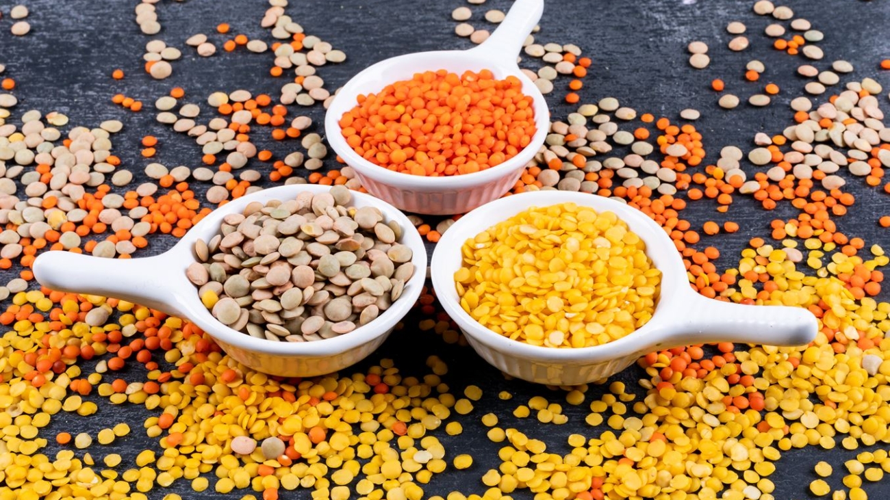 different-lentils-mini-white-spice-bowls-black-stone-table-side-view2-min